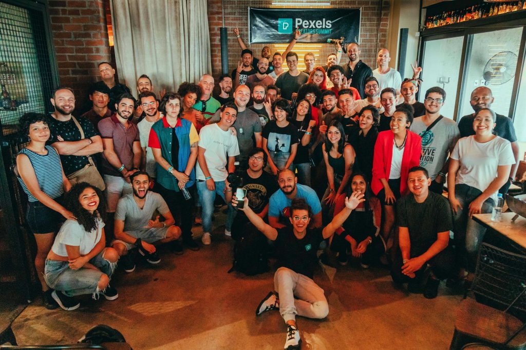 Group of professionals posing together at the end of a conference, celebrating connections made