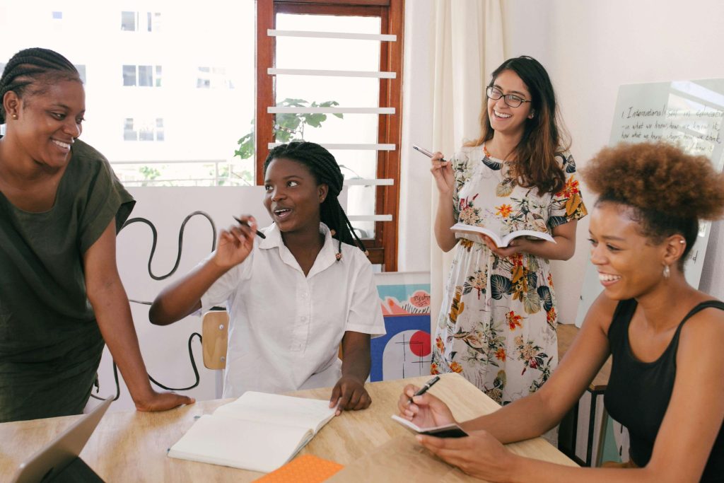 A mastermind group session at an event, with participants engaging in collaborative discussions about social impact and sustainability.